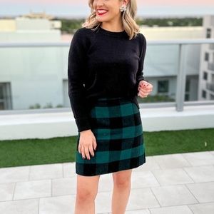 Black sweater and plaid skirt from J. Crew